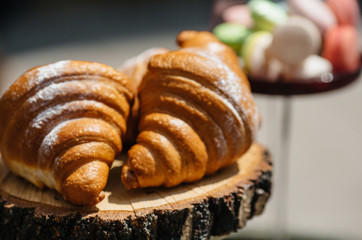 Tasty fresh croissants on grey wooden background