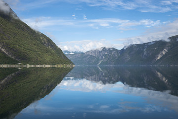 reflection of the mountains in fjord in norway