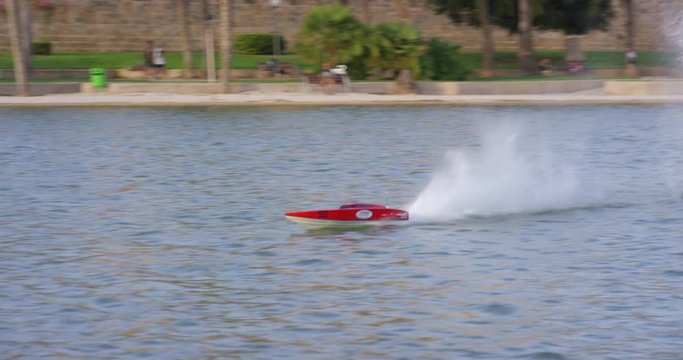 Radio controlled model of a motor torpedo boat on a boating lake. Palpa de Mallorca, Spain. Shot on 4k