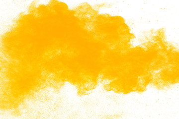 abstract yellow powder splatted on white background,Freeze motion of yellow powder explosion.