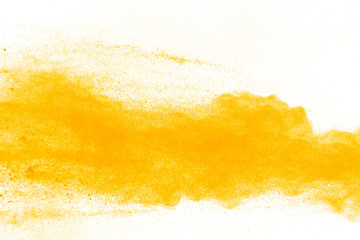 abstract yellow powder splatted on white background,Freeze motion of yellow powder explosion.