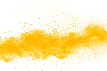 abstract yellow powder splatted on white background,Freeze motion of yellow powder explosion.