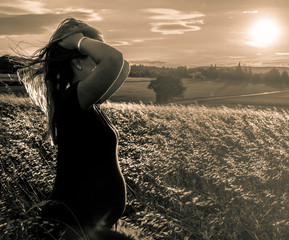 Maternity shot in wheat field with sunset