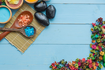 spa and massge items lay on blue wooden background