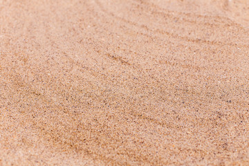 Fototapeta na wymiar Sand on the beach as background with space for the text. Sea travel and holiday. Selective focus
