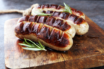 Grilled sausages with sauce ketchup on a wooden table - Home-made Pork Sausages