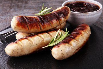 Grilled sausages with sauce ketchup on a wooden table - Home-made Pork Sausages