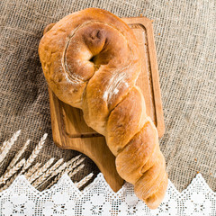 delicious baked goods on a wooden cutting board, near the wheat. Flat lay, copyspace for text