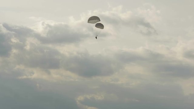 Paratrooper landing with two parachutes - slowmotion 60fps
