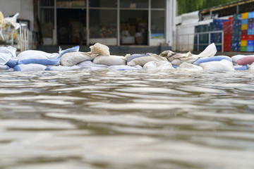 Flood water - Sandbags for flood defense - 167379952