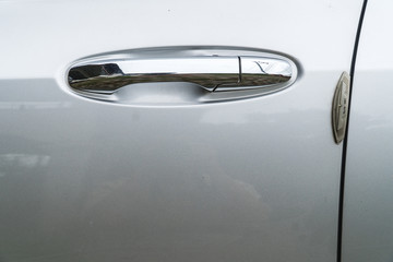Silver car door handle.