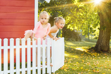 Fototapeta premium The two little girls at playground against park or green forest
