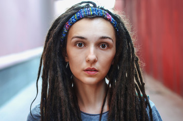 Fototapeta premium Portrait of a beautiful girl with dreadlocks