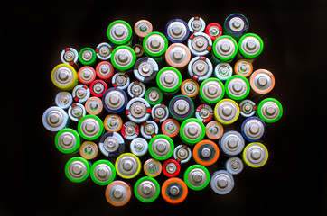 Electric batteries and accumulators size AAA AA. Battery on a black background.