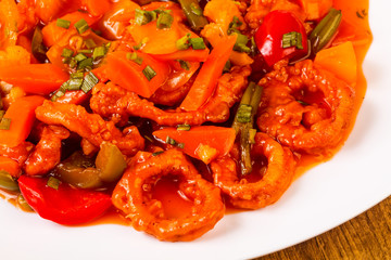 Squid rings in sweet and sour sauce with vegetables