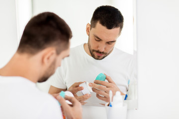 young man with cream at bathroom