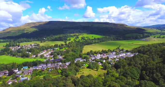 4K aerial footage of the rural village of Fintry in Scotland nestled beneath the Campsie Fells and Fintry Hills
