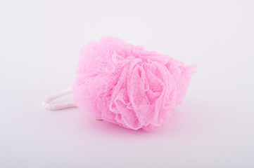 Soft pink bath puff or sponge isolated on white background