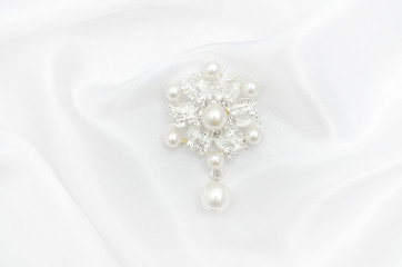 Brooch flower with pearls on silk fabric