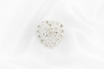 Brooch silver heart with diamonds  on white silk