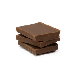 Milk chocolate pieces isolated on white background