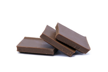 Milk chocolate pieces isolated on white background
