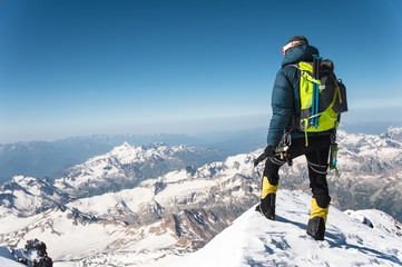Professional guide - climber on the snow-covered summit of Elbrus sleeping volcano