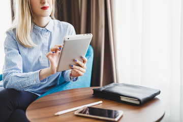 Obraz premium Close-up view of a business woman working on her tablet pc in a hotel room