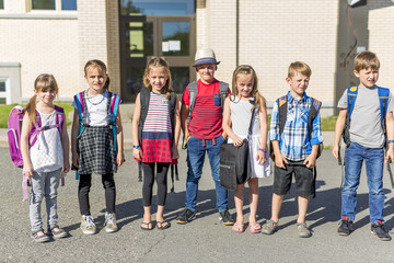 Portrait Of School Pupils Outside Classroom Carrying Bags
