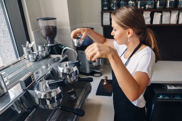 Portrait of Caucasian barista woman with two cups of fresh espresso cappuccino. Waitress serving holding hot drinks. Preparing coffee in restaurant shop cafe. Busy life of local small business.