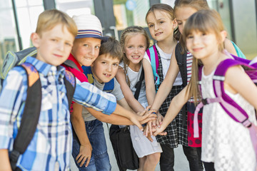 Portrait Of School Pupils Outside Classroom Carrying Bags