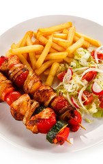 Kebabs - grilled meat and vegetables on white background