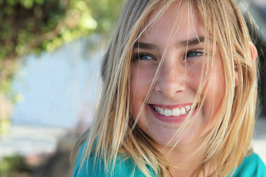 Young Blonde Girl Laughing With Hair In Face