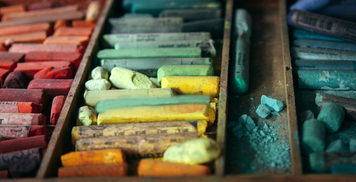 Wood box full of well loved oil pastel crayons