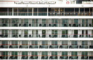Many balconies with furniture on a cruise ship