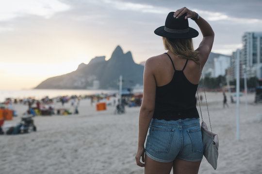 Rio de Janeiro. Brazil. Woman walking on the beach at sunset