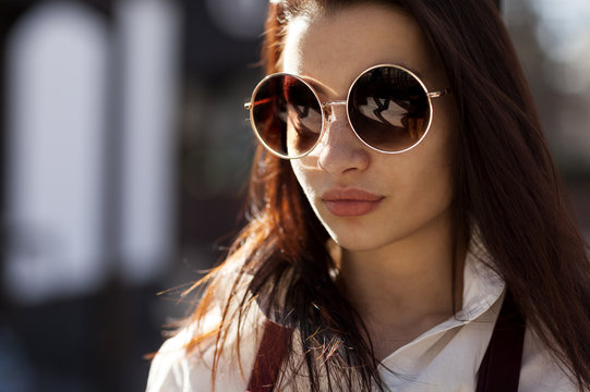 Beautiful young woman with vintage sunglasses