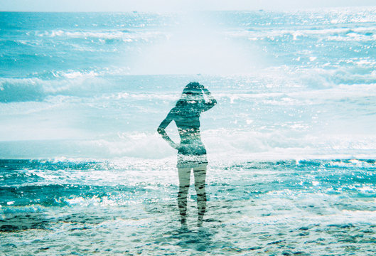 Woman standing in the ocean