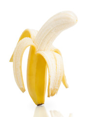 Half peeled banana isolated on a white background