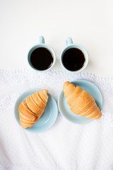 cup of coffee with croissant