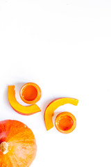 Baby food. Pumpkin puree on white background top view copyspace