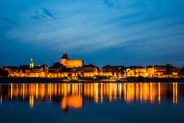 Fototapeta na wymiar Night view of Torun city and Vistula river, Poland