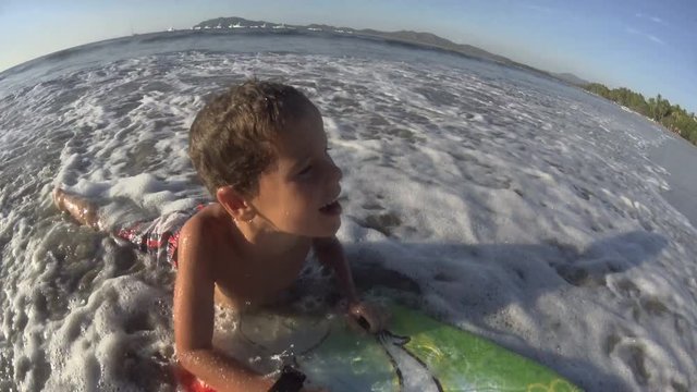 Boy / kid surfing - jumping waves Body Board / boarding at the beach, surfing, surf