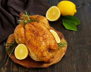 Baked whole chicken with lemon and herbs.