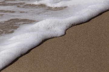 Sea waves on tropical beach in summer day