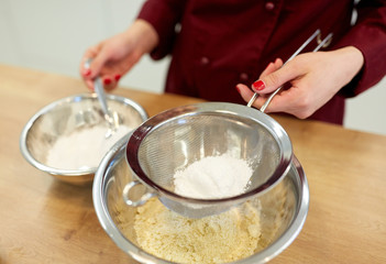 chef with flour in bowl making batter or dough