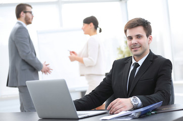 successful businessman sitting at Desk in office