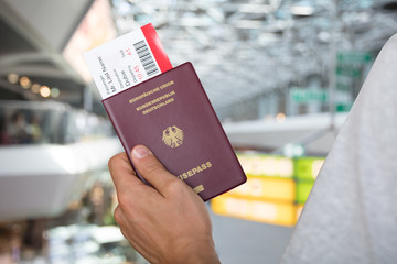 Hand Holding Passport And Boarding Pass