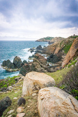 Obraz premium Coastline with the cliff and the rock in Cu Lao Xanh island Qui Nhon Vietnam