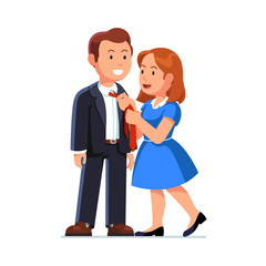 Wife in dress knotting husbands neck tie